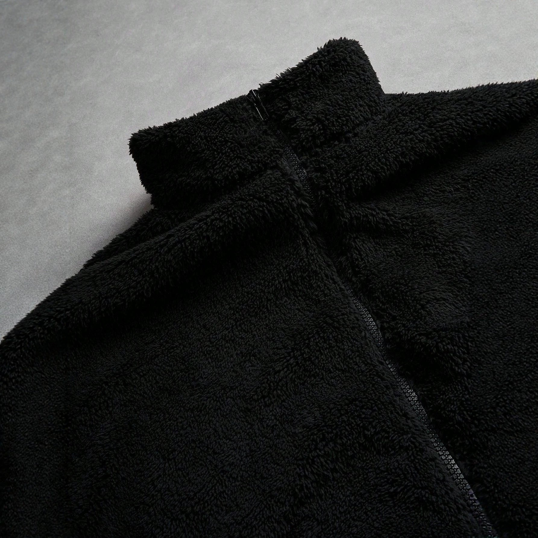 Black Furry Jacket With A Zipper And Embroidery On The Left Chest